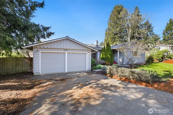 a view of a house with a yard and garage