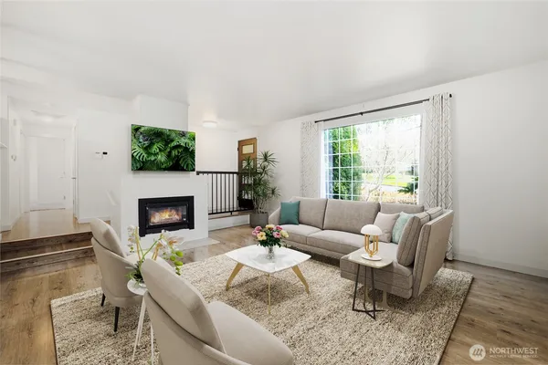 a living room with furniture a fireplace and a table