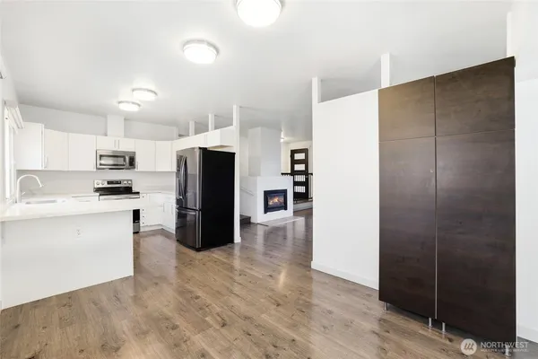 a kitchen with stainless steel appliances a refrigerator and cabinets