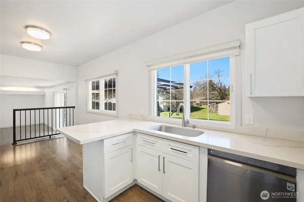 a kitchen with a sink stove and cabinets