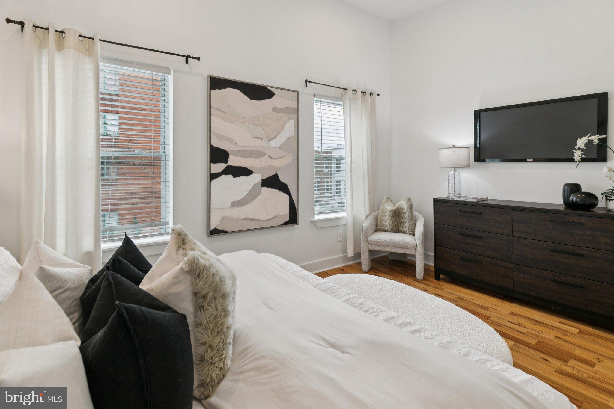 1537 Reed Street Philadelphia, PA 19146 - Photo 14 of 32 a bedroom with a bed and a flat tv screen on dresser