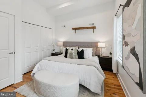 a bedroom with a bed and a mirror