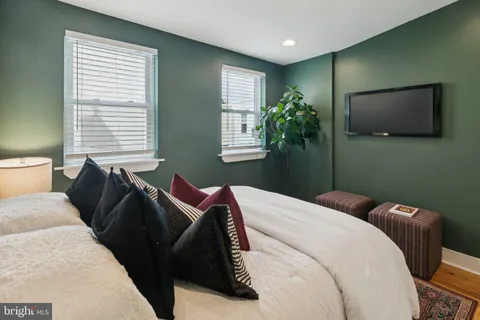 a bedroom with a bed and a television