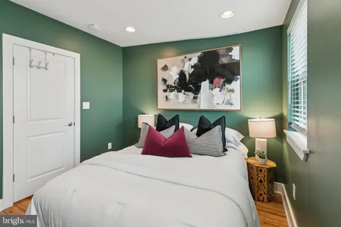 a bedroom with a bed and wall painting