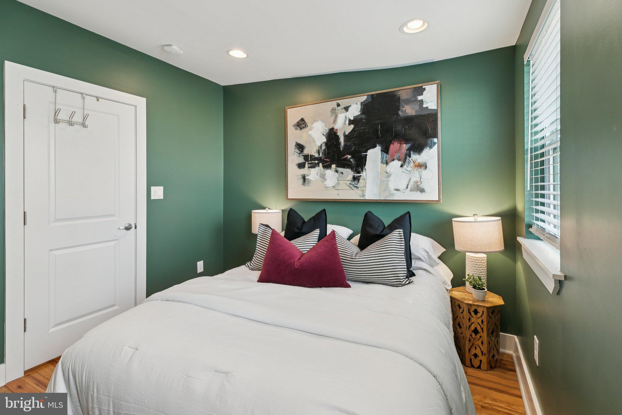 1537 Reed Street Philadelphia, PA 19146 - Photo 22 of 32 a bedroom with a bed and wall painting