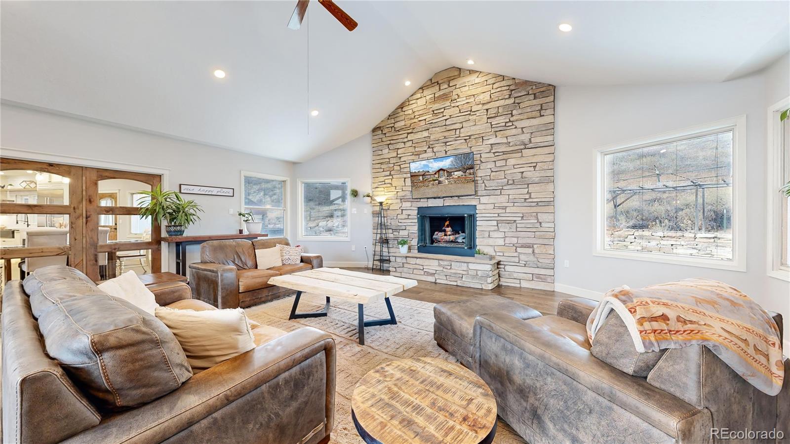 5575 Spring Glade Road Loveland, CO 80538 - Photo 14 of 49 a living room with furniture and a fireplace