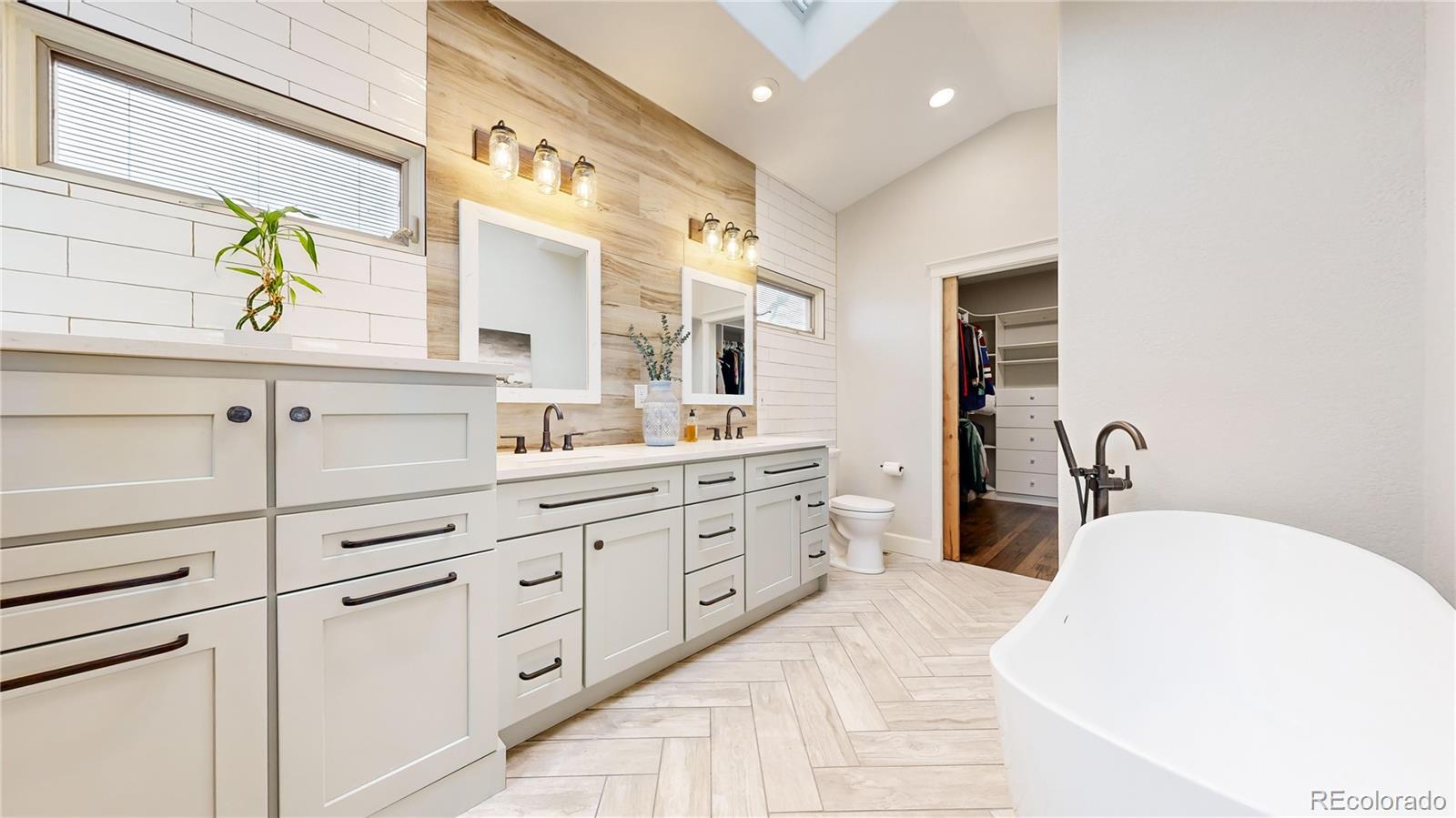 5575 Spring Glade Road Loveland, CO 80538 - Photo 18 of 49 a spacious bathroom with a double vanity sink double and mirror
