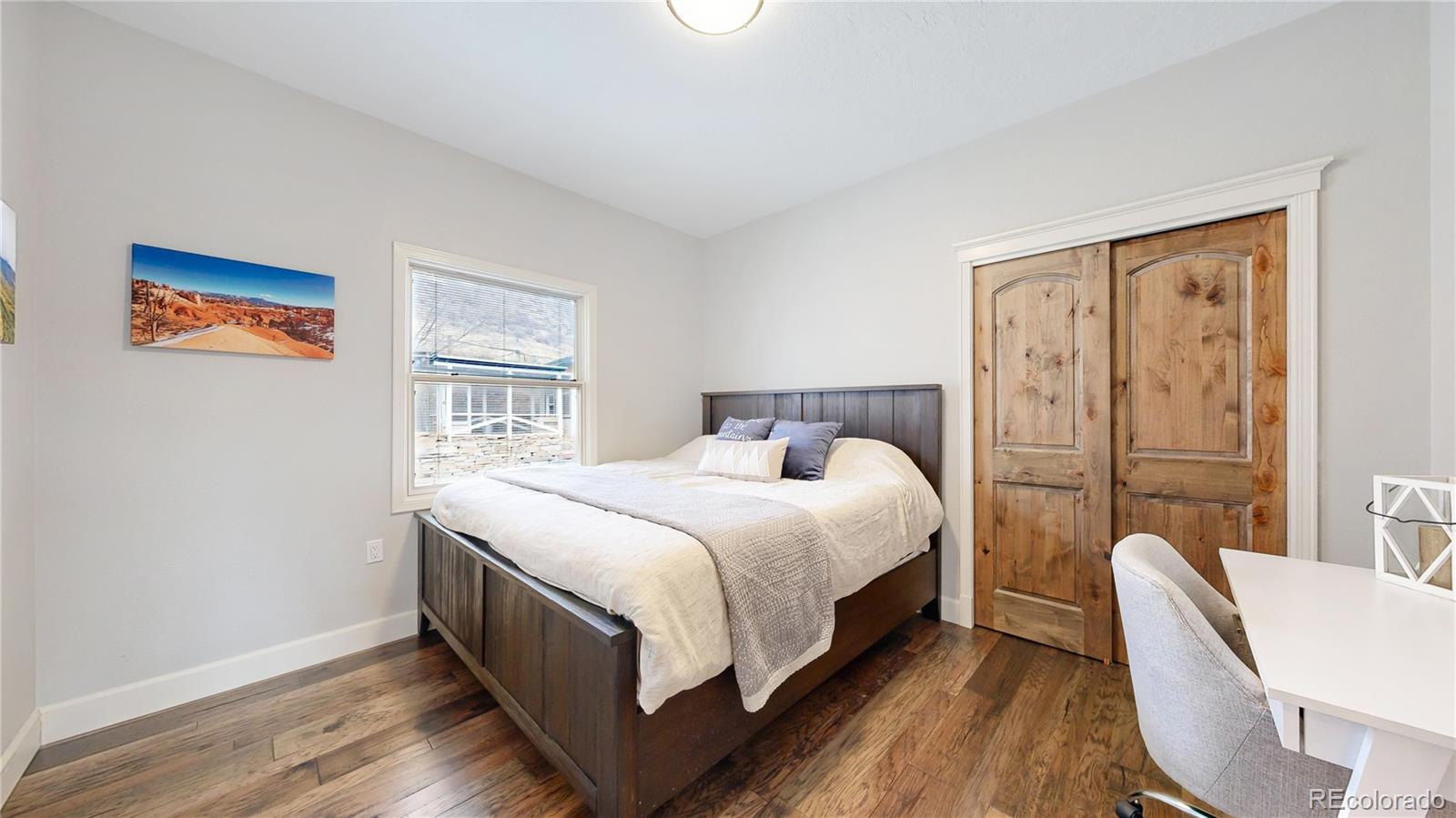 5575 Spring Glade Road Loveland, CO 80538 - Photo 22 of 49 a bed room with a bed and a chair