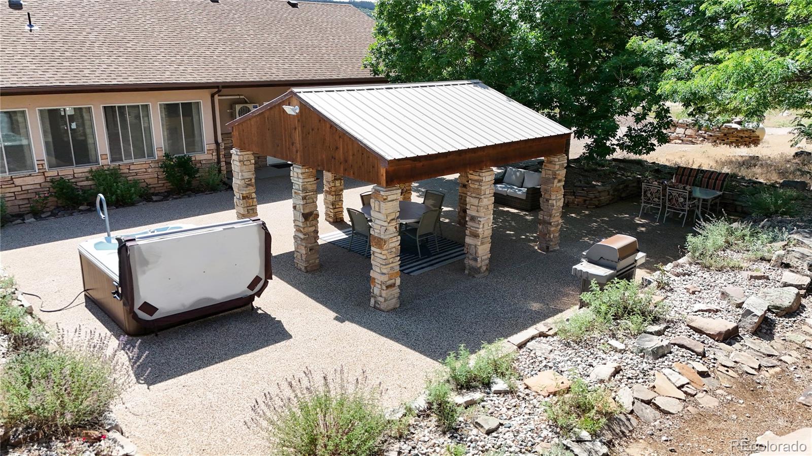 5575 Spring Glade Road Loveland, CO 80538 - Photo 38 of 49 a view of a patio with table and chairs and potted plants