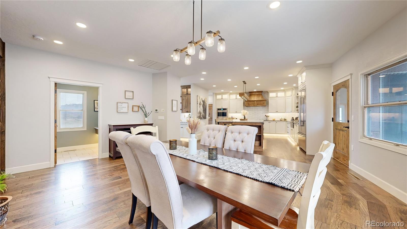 5575 Spring Glade Road Loveland, CO 80538 - Photo 10 of 49 a dining room with furniture and wooden floor