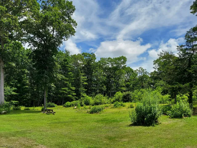 a living room with furniture a flat screen tv and a large window