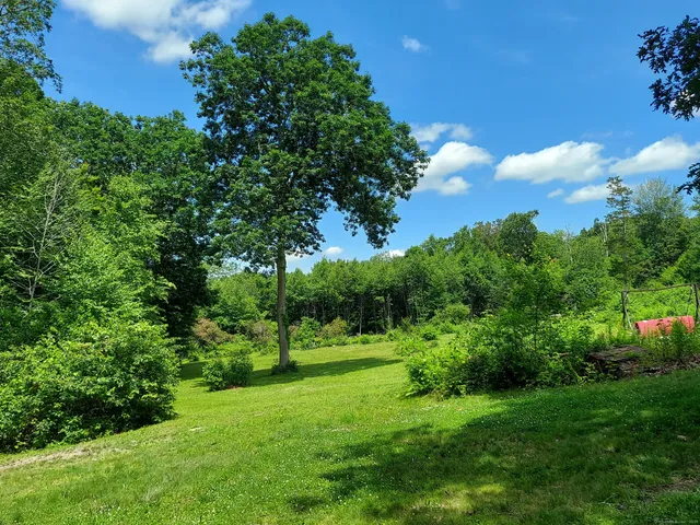 a dining room with furniture a chandelier and wooden floor