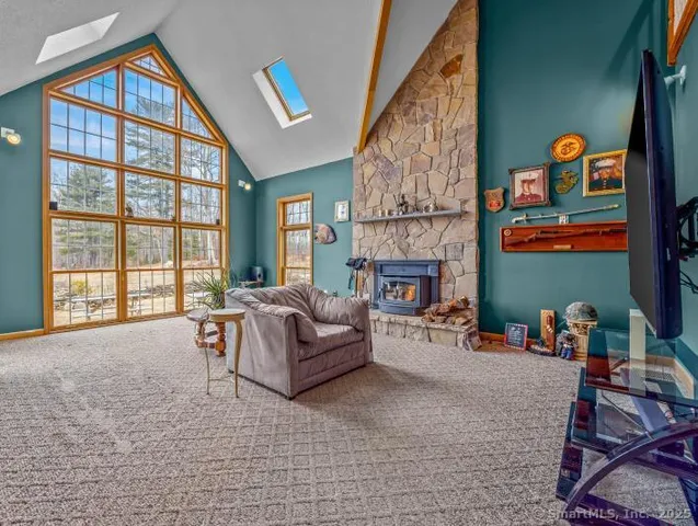 a dining room with furniture a chandelier and wooden floor
