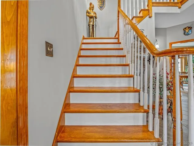 a bathroom with a toilet mirror vanity and shower