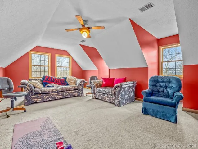 a bedroom with a bed a chandelier and dresser