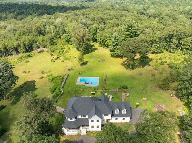 an aerial view of a houses with yard