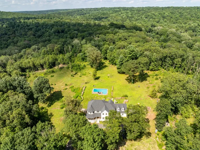 a view of a swimming pool with an outdoor space and seating area