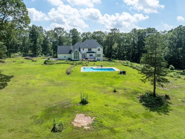 a view of a swimming pool and trees in the background