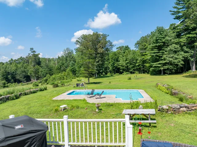 a view of a swimming pool with an outdoor space and seating area