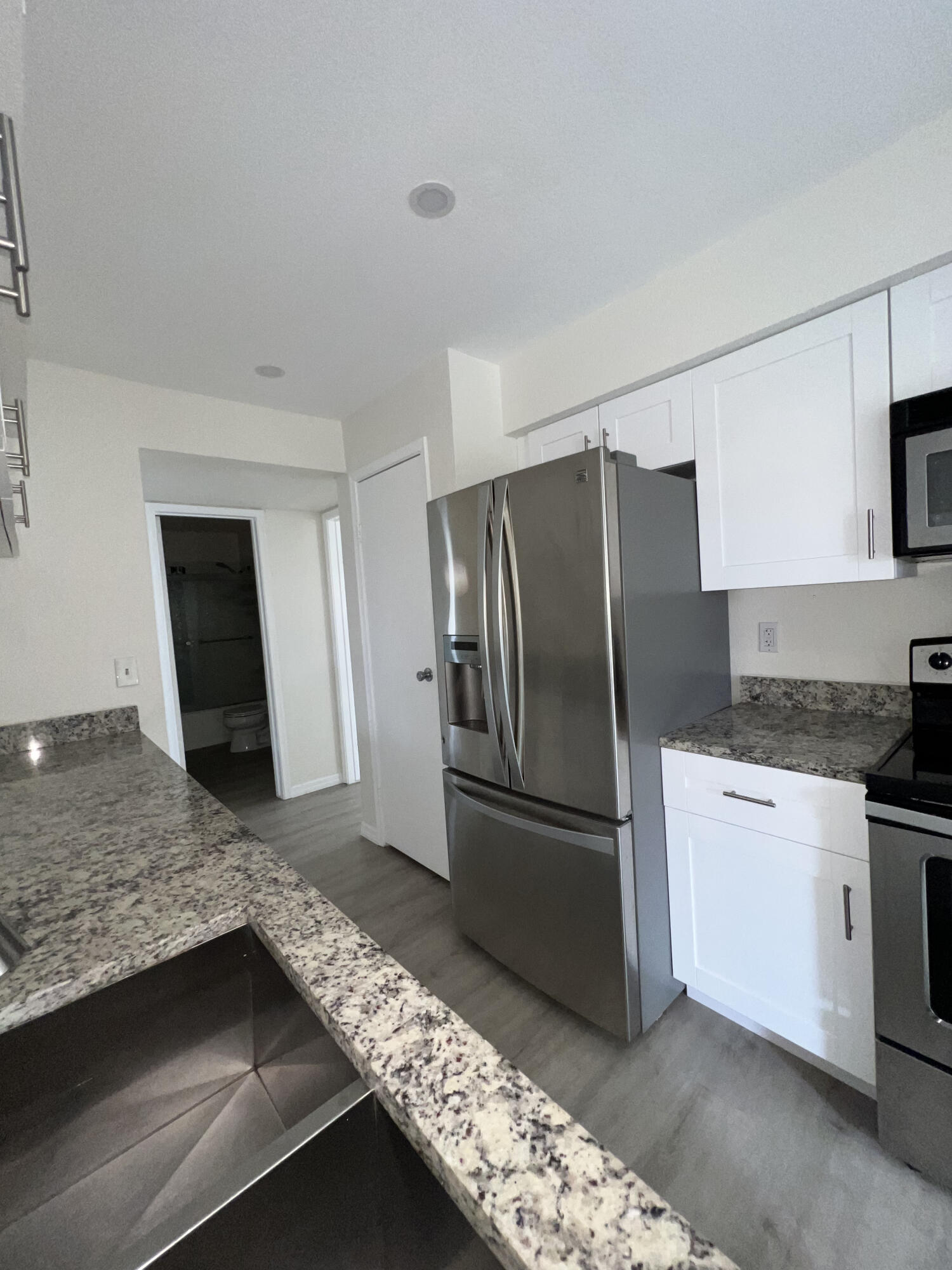899 Riverside Drive, Unit 620 Coral Springs, FL 33071 - Photo 14 of 46 a kitchen with granite countertop a refrigerator and a sink