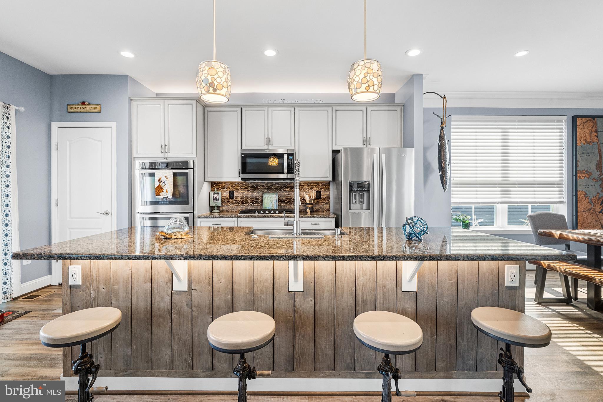 36207 Watch Hill Road Frankford, DE 19945 - Photo 7 of 35 a kitchen with stainless steel appliances a sink a table and chairs