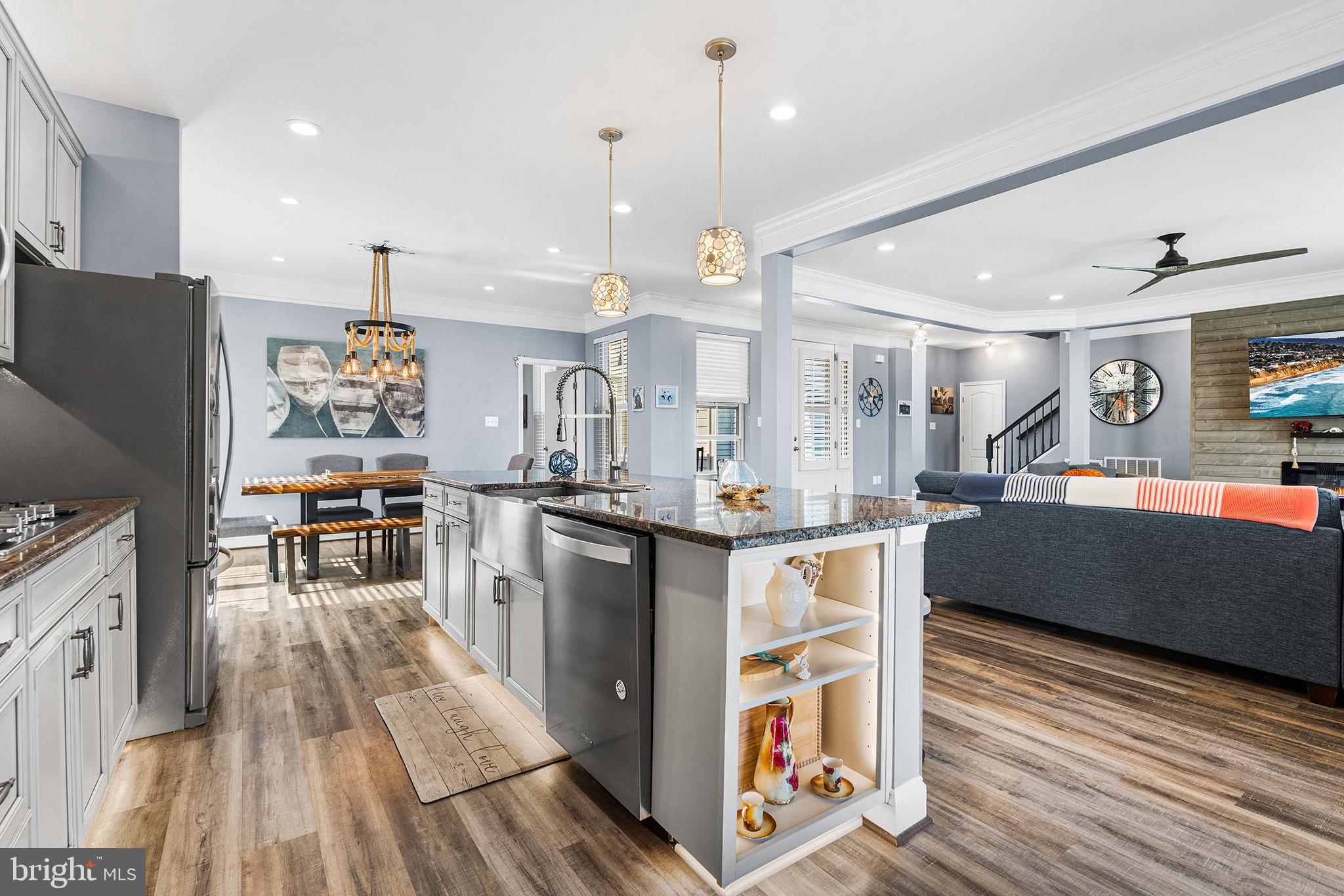 36207 Watch Hill Road Frankford, DE 19945 - Photo 9 of 35 a kitchen with stainless steel appliances granite countertop a refrigerator a sink dishwasher a stove and white cabinets with wooden floor