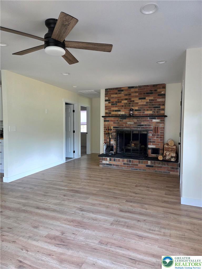 89 Short Ridge Road Albrightsville, PA 18210 - Photo 11 of 71 An inviting wood-look floor anchors this room featuring a classic brick hearth.