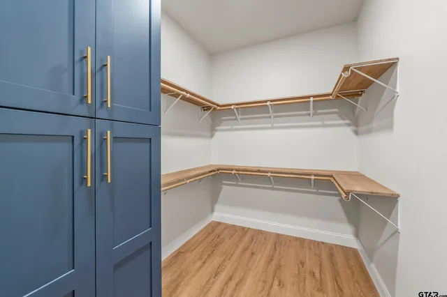 a view of a room with wooden floor and white walls