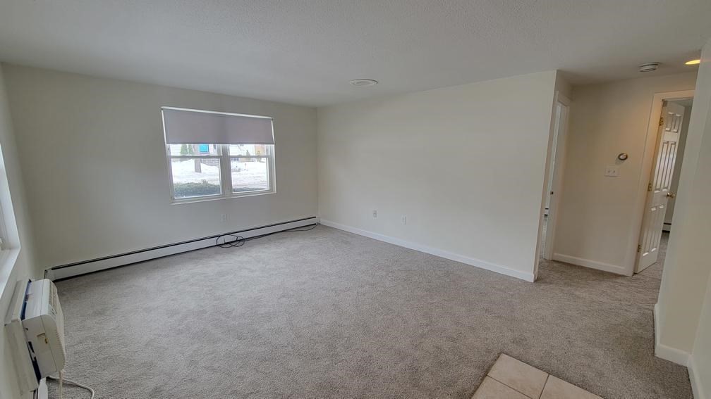 6 Whitman Road, Unit 6 Waltham, MA 02453 - Photo 1 of 12 an empty room with windows