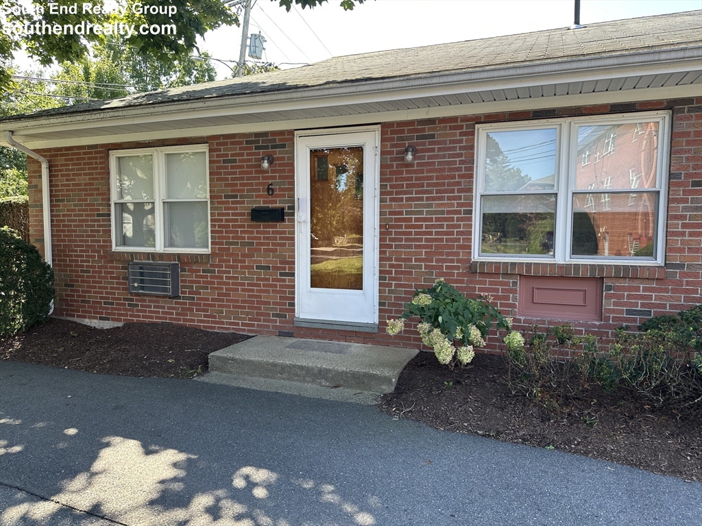 6 Whitman Road, Unit 6 Waltham, MA 02453 - Photo 11 of 12 a front view of a house with a yard