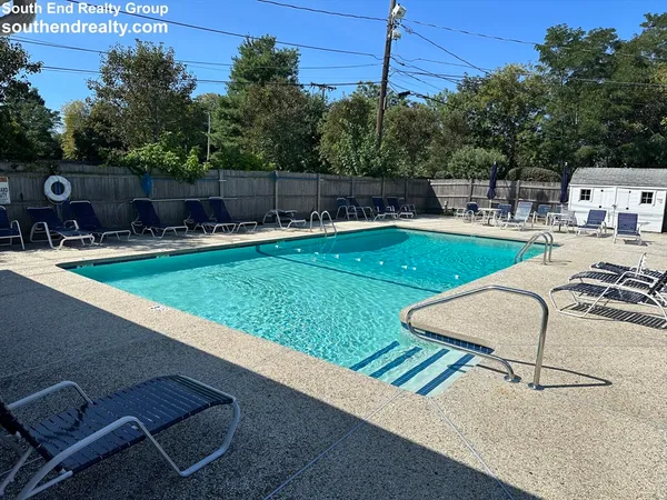 swimming pool view with a seating space