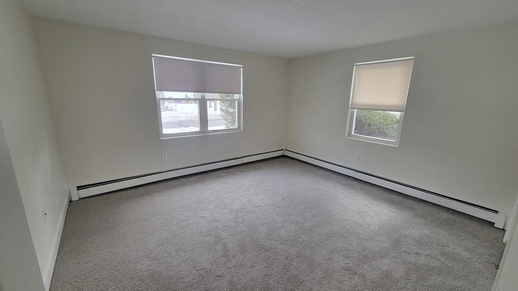 6 Whitman Road, Unit 6 Waltham, MA 02453 - Photo 6 of 12 an empty room with a window