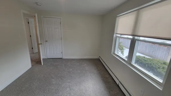 a view of an empty room with a window