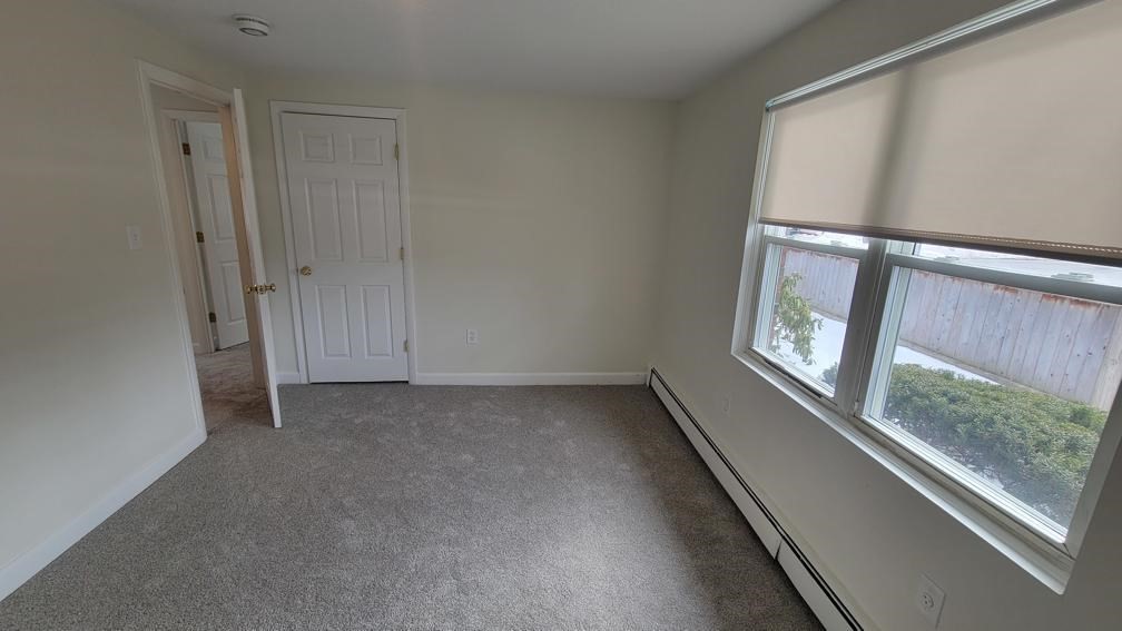 6 Whitman Road, Unit 6 Waltham, MA 02453 - Photo 9 of 12 a view of an empty room with a window