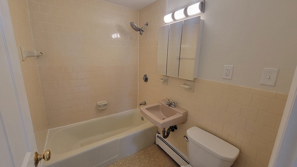 6 Whitman Road, Unit 6 Waltham, MA 02453 - Photo 10 of 12 a bathroom with a sink a toilet and shower