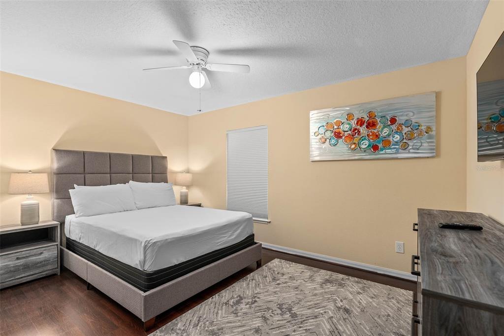 1030 Coventry Road Davenport, FL 33897 - Photo 20 of 48 a bedroom with a bed and a chandelier