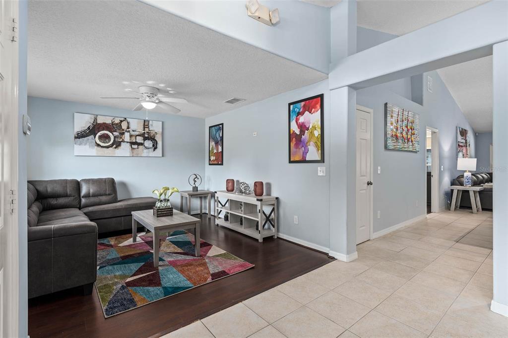 1030 Coventry Road Davenport, FL 33897 - Photo 2 of 48 a living room with furniture and wooden floor