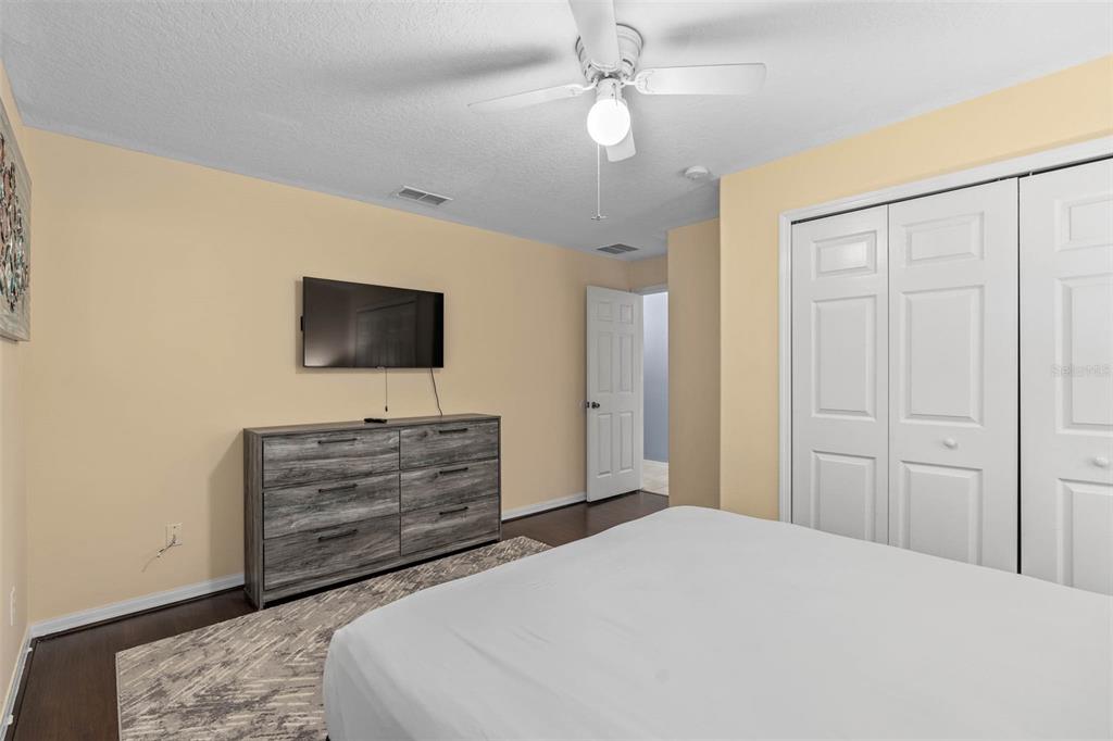 1030 Coventry Road Davenport, FL 33897 - Photo 21 of 48 a bedroom with a bed and a flat screen tv