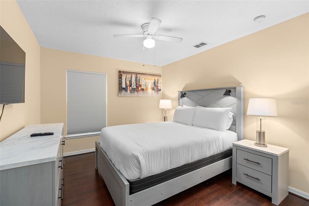 1030 Coventry Road Davenport, FL 33897 - Photo 22 of 48 a bedroom with a bed and a night stand