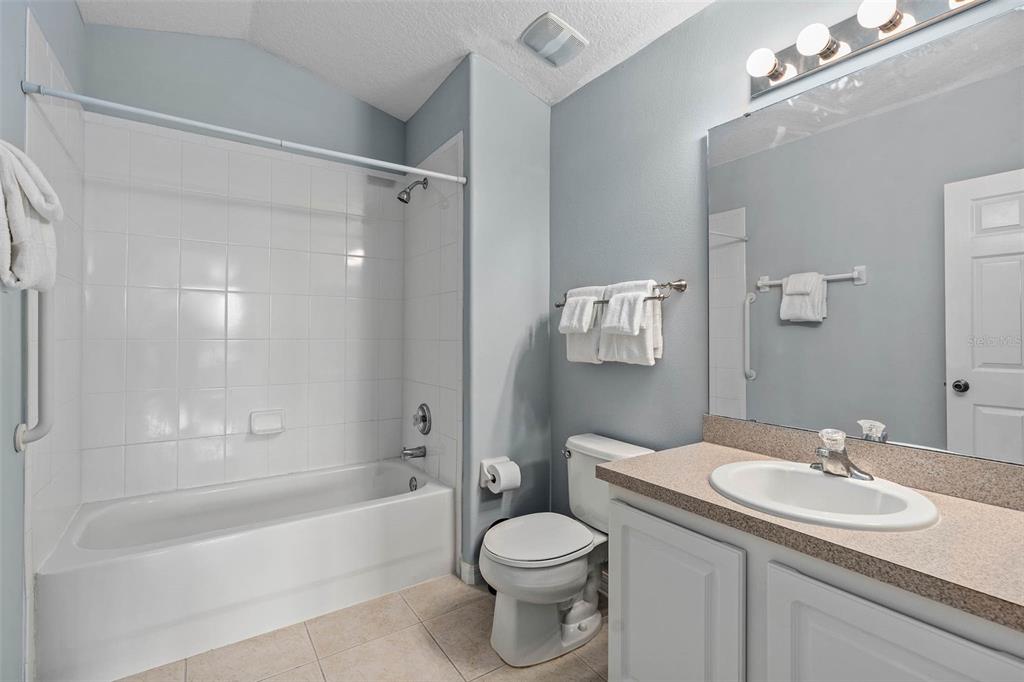 1030 Coventry Road Davenport, FL 33897 - Photo 29 of 48 a bathroom with a sink toilet and shower