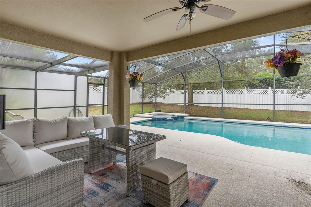 1030 Coventry Road Davenport, FL 33897 - Photo 30 of 48 a living room with furniture and a floor to ceiling window