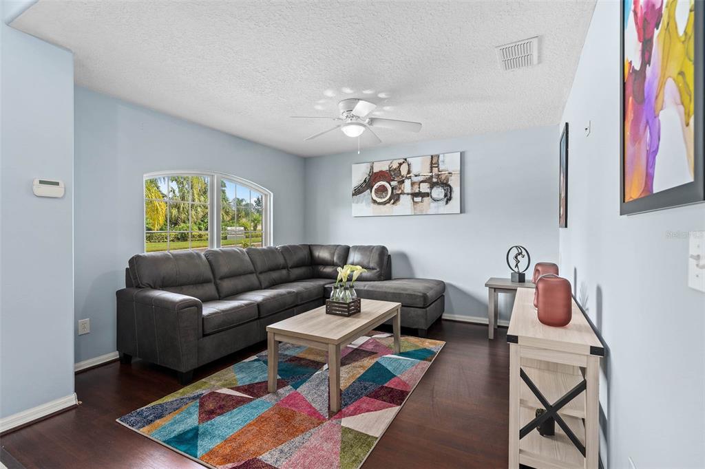 1030 Coventry Road Davenport, FL 33897 - Photo 3 of 48 a living room with furniture and a book shelf