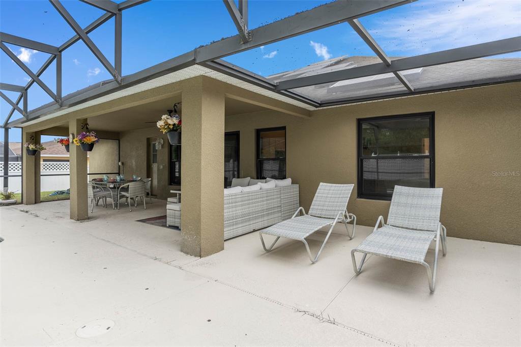 1030 Coventry Road Davenport, FL 33897 - Photo 38 of 48 a view of a patio with a table and chairs