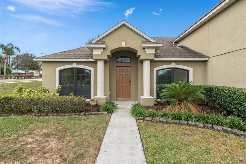 1030 Coventry Road Davenport, FL 33897 - Photo 39 of 48 a front view of a house with garden