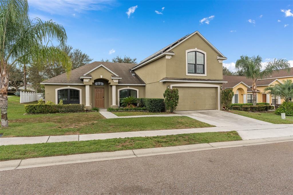 1030 Coventry Road Davenport, FL 33897 - Photo 40 of 48 a front view of a house with a garden and yard