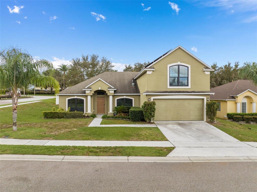 1030 Coventry Road Davenport, FL 33897 - Photo 42 of 48 a front view of a house with a yard and garage