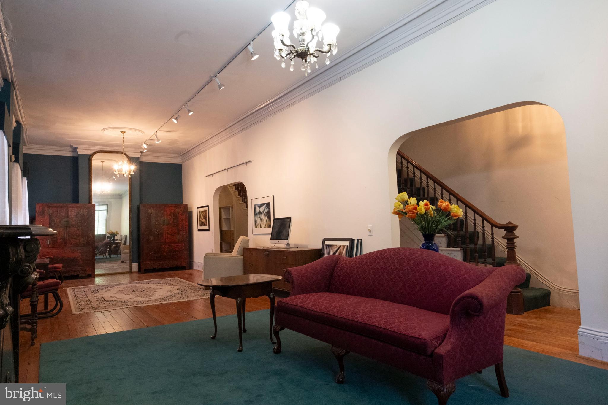 19 South Stricker Street Baltimore, MD 21223 - Photo 13 of 55 a living room with furniture and a chandelier