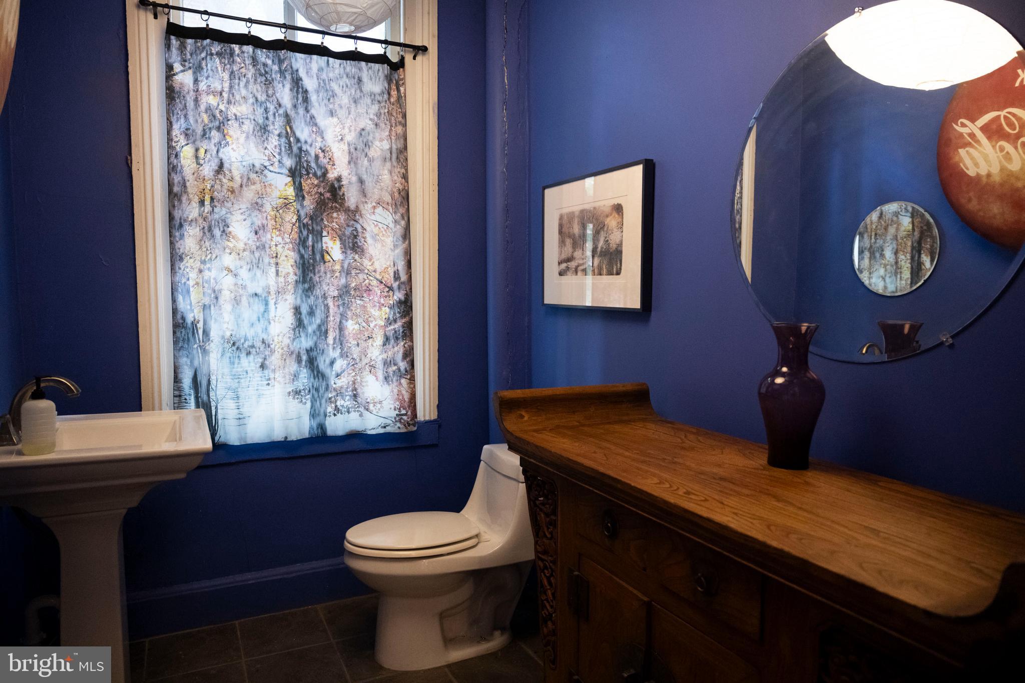 19 South Stricker Street Baltimore, MD 21223 - Photo 24 of 55 a bathroom with a granite countertop toilet sink and mirror