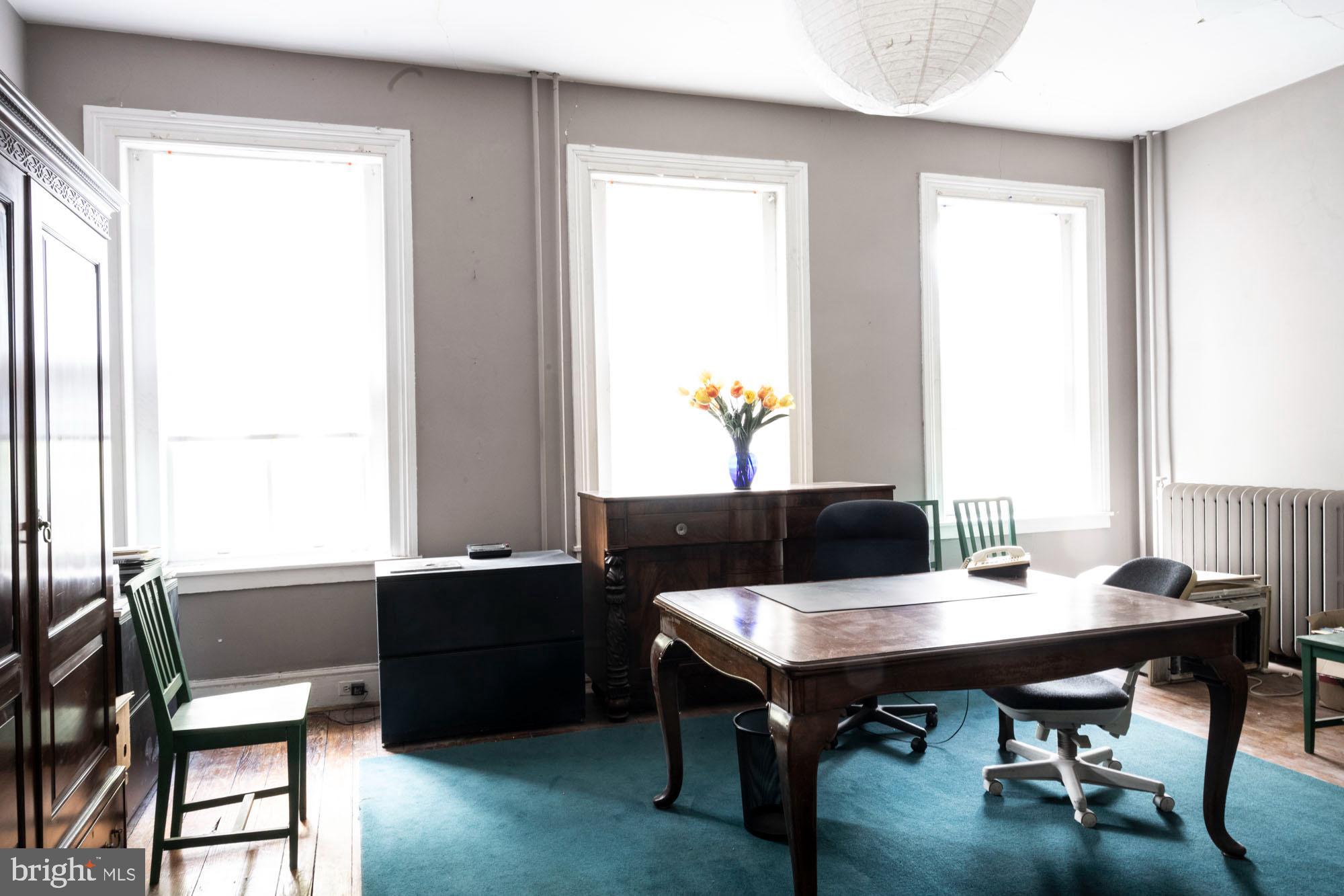19 South Stricker Street Baltimore, MD 21223 - Photo 35 of 55 a view of a workspace with a window and dining table