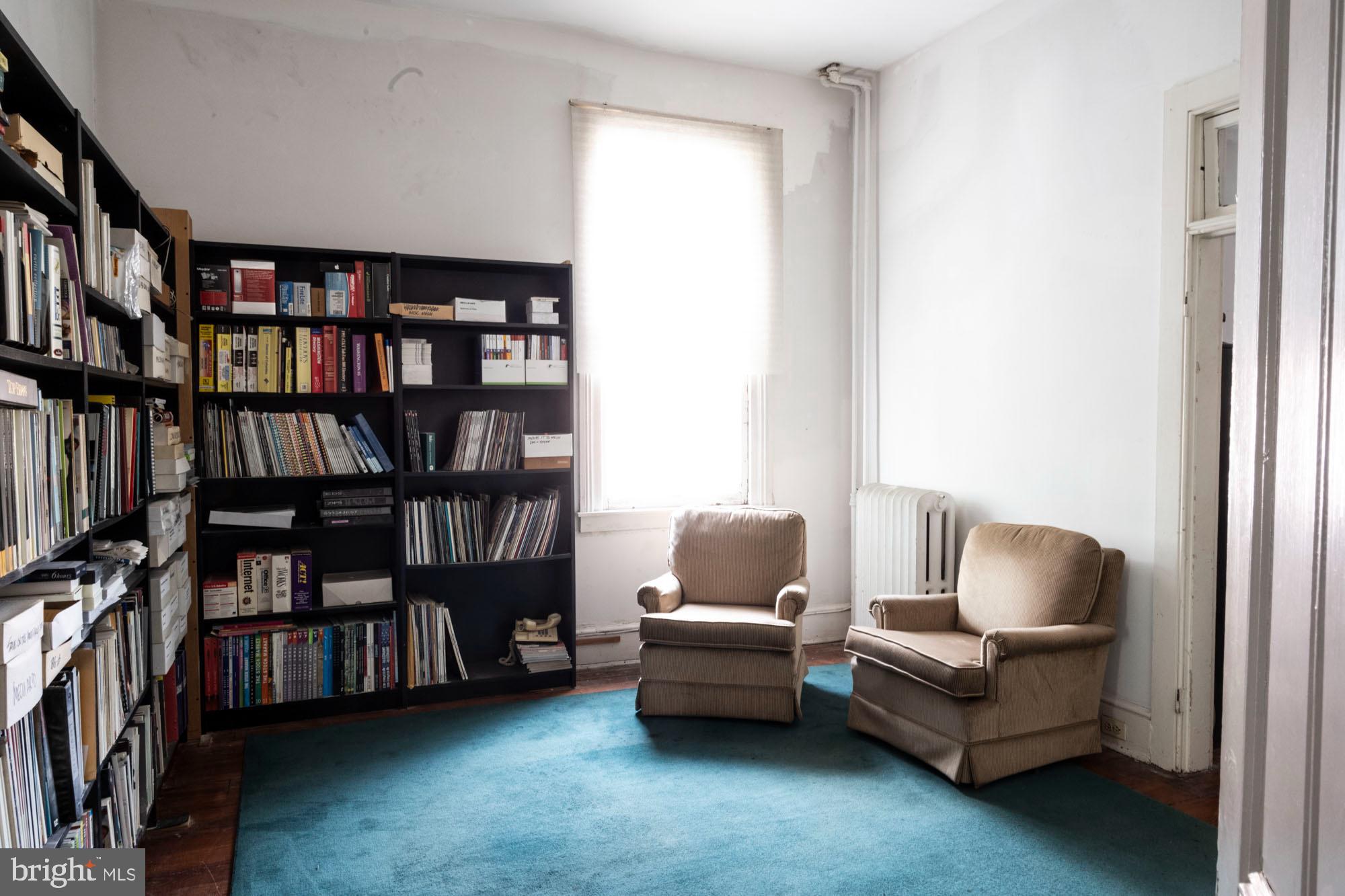 19 South Stricker Street Baltimore, MD 21223 - Photo 39 of 55 a living room with furniture and a book shelf